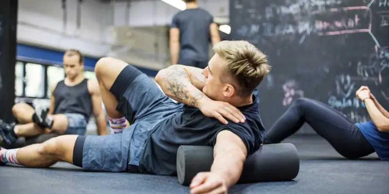 man using foam roller to relax muscle