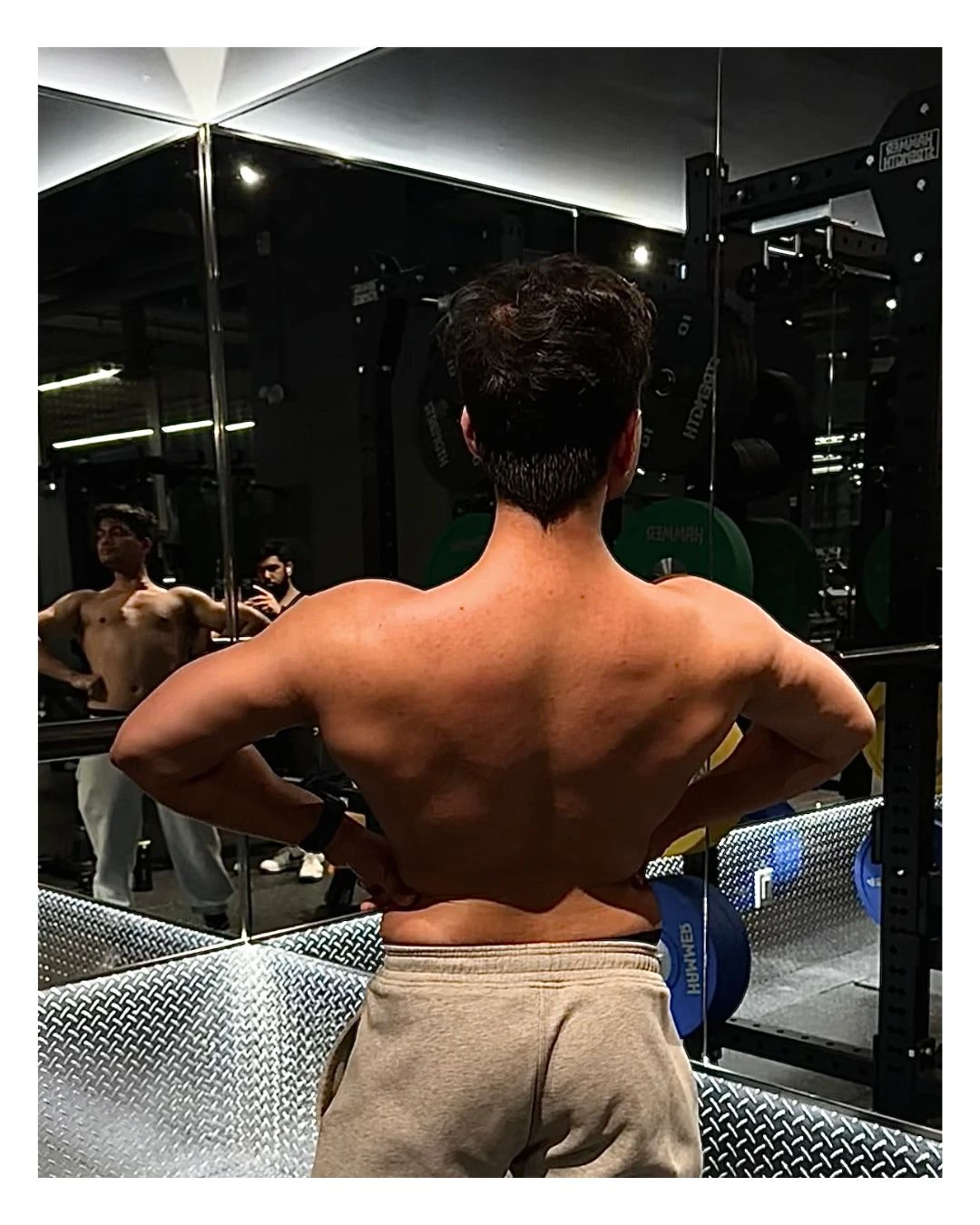 Mehul Ahire body recomposition results showing muscle development in gym mirror